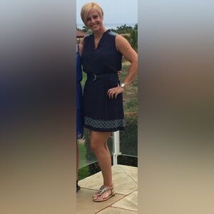 Navy mini dress with embroidered design.